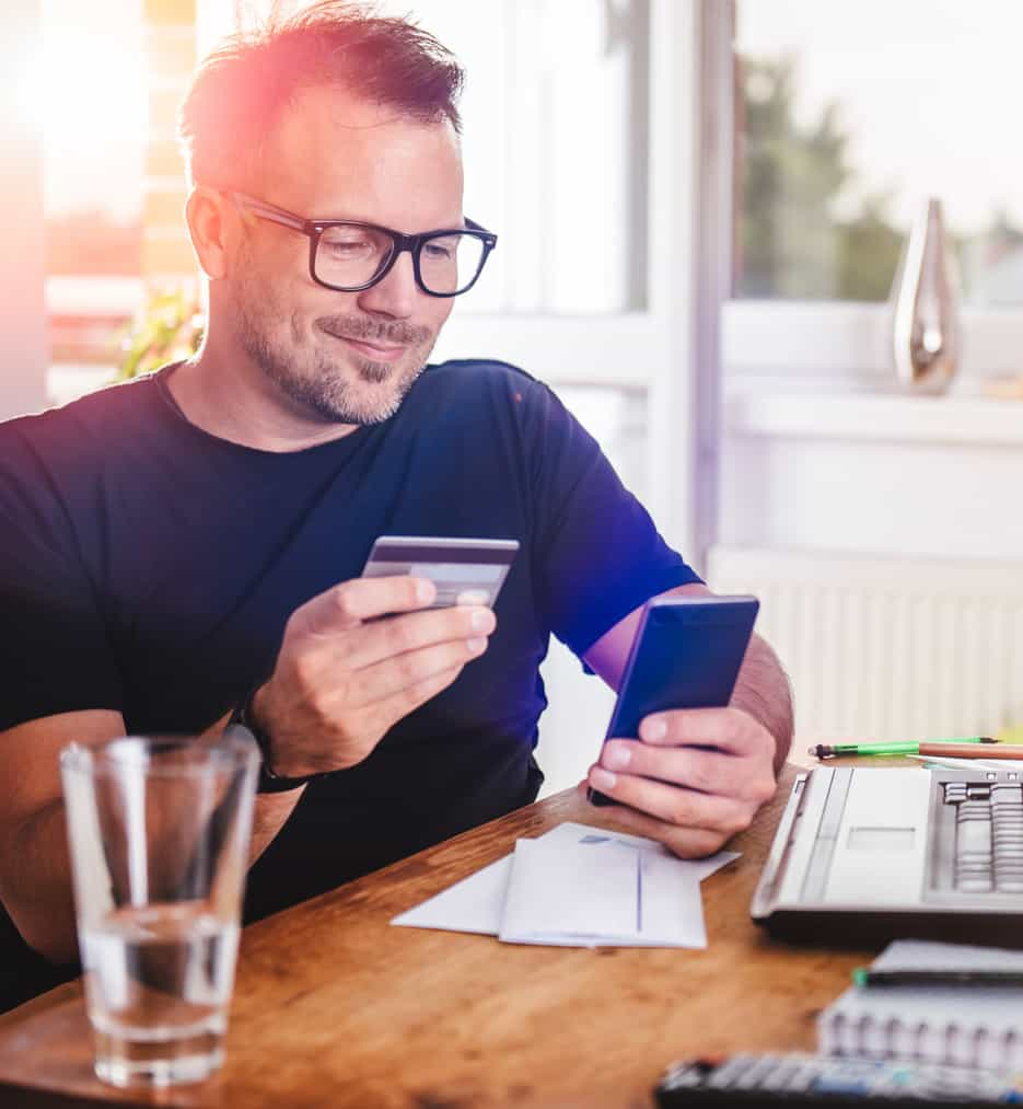 Man looking at his credit card.