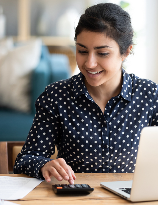 Teen on computer investing money.