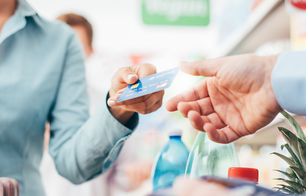 Woman using credit card for groceries