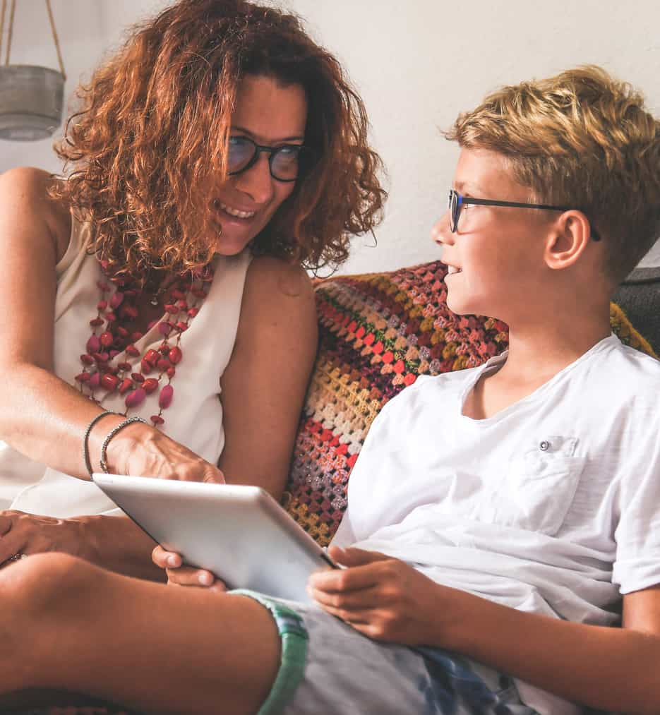 Mom and teen son on new laptop.