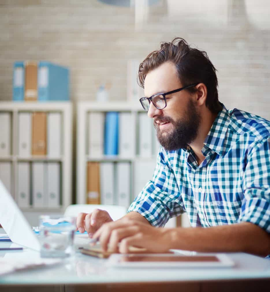 Middle age guy looking at laptop.