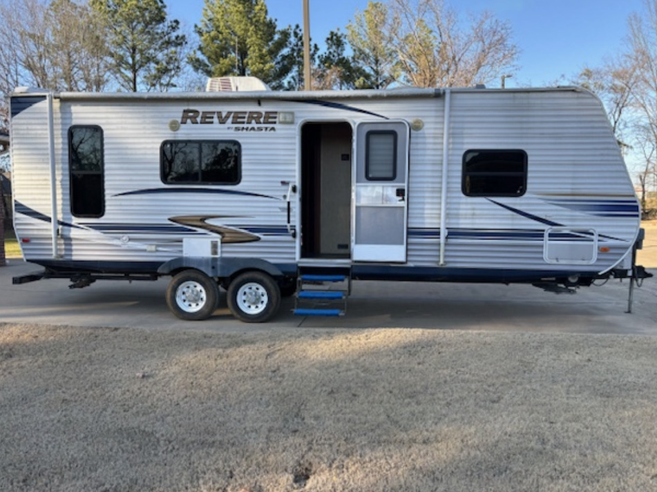 Repo - 2012 Shasta by Forest River M-25RKSS - color white with gray and blue.