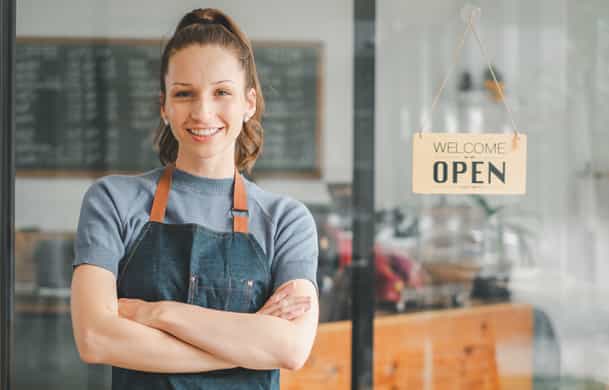 Young business owner standing in storefront